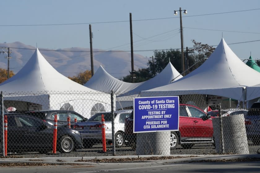 Cars line up at a County of Santa Clara COVID-19 testing site during the coronavirus pandemic in San Jose, Calif., Tuesday, Dec. 1, 2020. (AP Photo/Jeff Chiu)