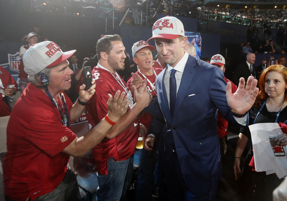 FILE - Fans celebrate with UCLA's Josh Rosen, center right, after Rosen was selected by the Arizona Cardinals during the first round of the NFL football draft, Thursday, April 26, 2018, in Arlington, Texas. The Minnesota Vikings need a quarterback in this draft. That much is easy to see. The hard part is picking the right one — and determining what it's worth to them to get him. (AP Photo/Michael Ainsworth, File)