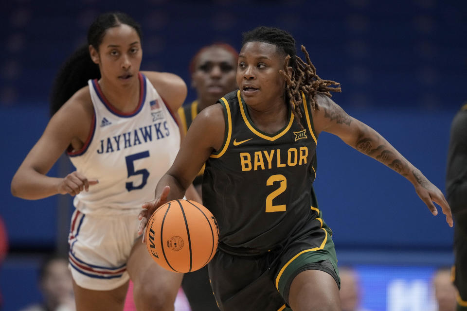 Baylor guard Yaya Felder (2) drives during the first half of an NCAA college basketball game against Kansas Wednesday, Jan. 10, 2024, in Lawrence, Kan. (AP Photo/Charlie Riedel)