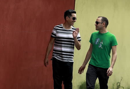 Same-sex couple Cristian Zamora (L) and Gerald Castro walk outside their house in San Jose June 3, 2015. REUTERS/Juan Carlos Ulate