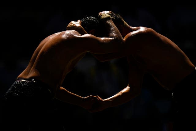 Wrestlers compete during the 661st annual Historic Kirkpinar Oil Wrestling championship, in Edirne, northwestern Turkey