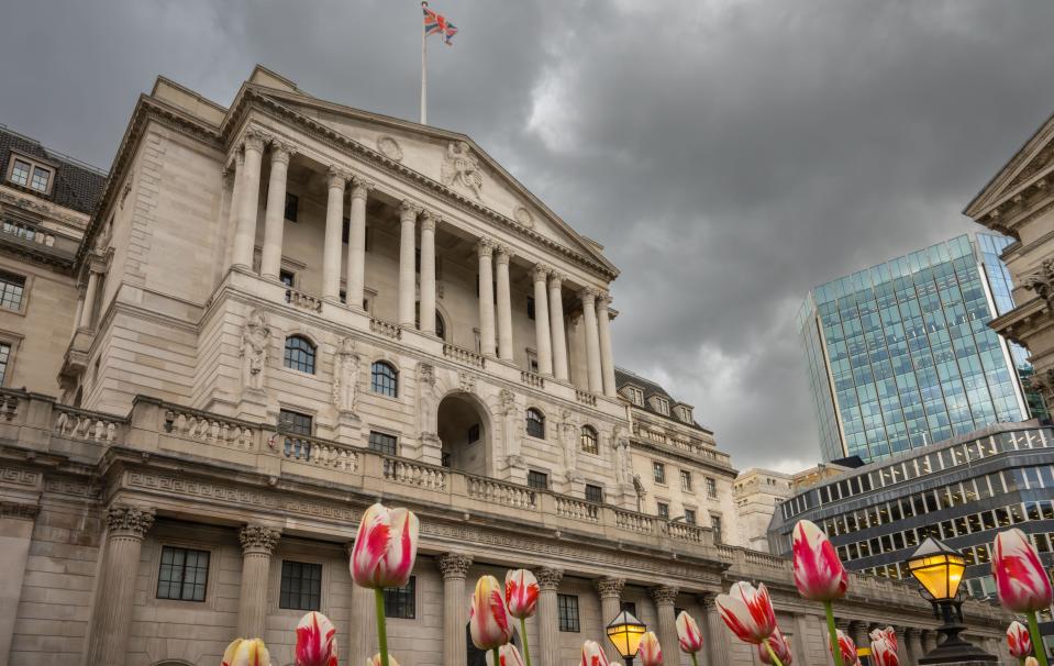 London, UK: Bank of England building in the City of London with tulips in the foreground.British business sentiment