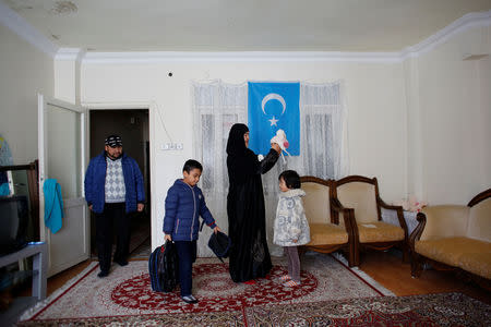 Qurbanjan Nourmuhammed and his wife Gulgine Mahmut get their children ready for school at their home in Istanbul, Turkey, February 28, 2019. REUTERS/Murad Sezer