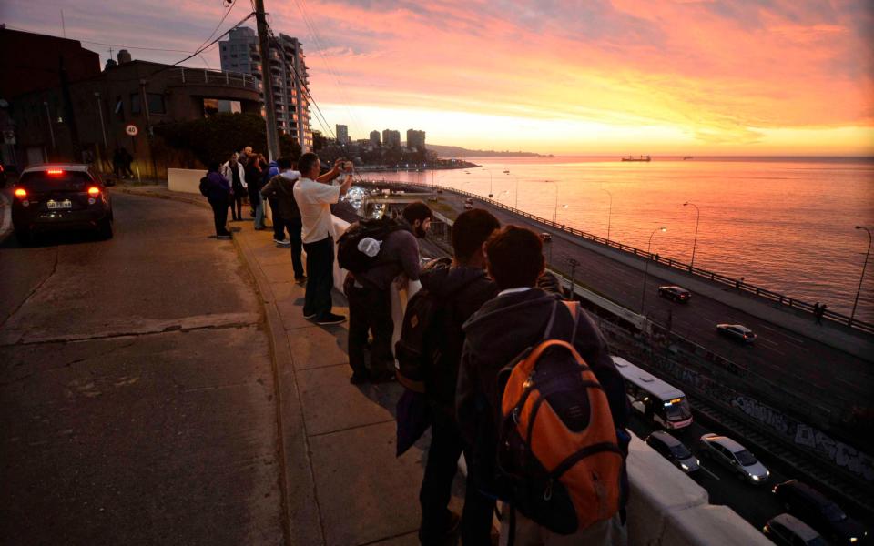 People remain in the street after the 7.1 quake in Vina del Mar, Chile - Credit: AFP