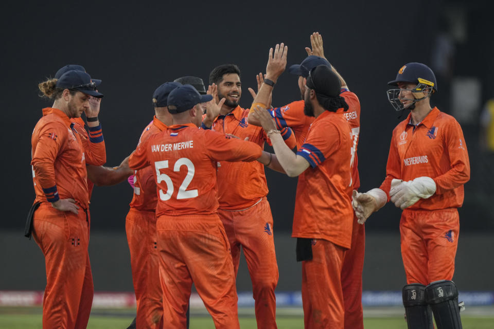 Netherlands' Aryan Dutt, center without cap, celebrates the wicket of New Zealand's Mark Chapman with his teammates during the ICC Men's Cricket World Cup match between New Zealand and Netherlands in Hyderabad, India, Monday, Oct. 9, 2023. (AP Photo/Mahesh Kumar A.)