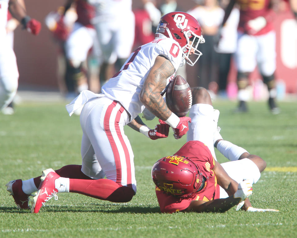 Oct. 29, 2022; Ames, Iowa; Oklahoma Sooners wide receiver Woodi Washington (0) intercepts the ball over Iowa State Cyclones wide receiver Dimitri Stanley (14) during the first quarter in the Big 12 Conference game at Jack Trice Stadium. Nirmalendu Majumdar/Ames Tribune-USA TODAY Sports