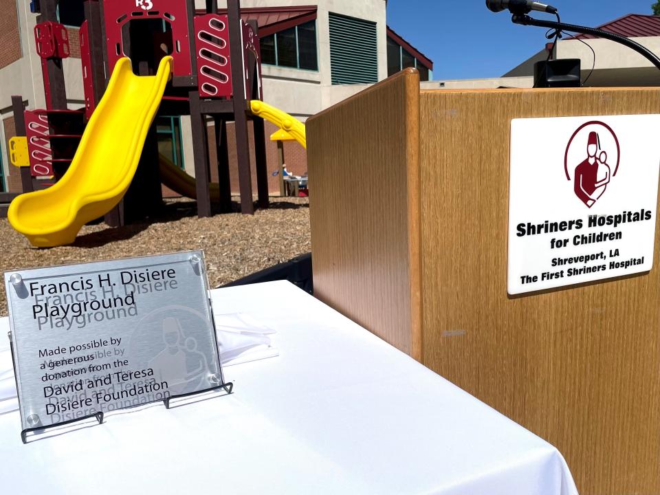 Francis H. Disiere plaque with the new playground behind.