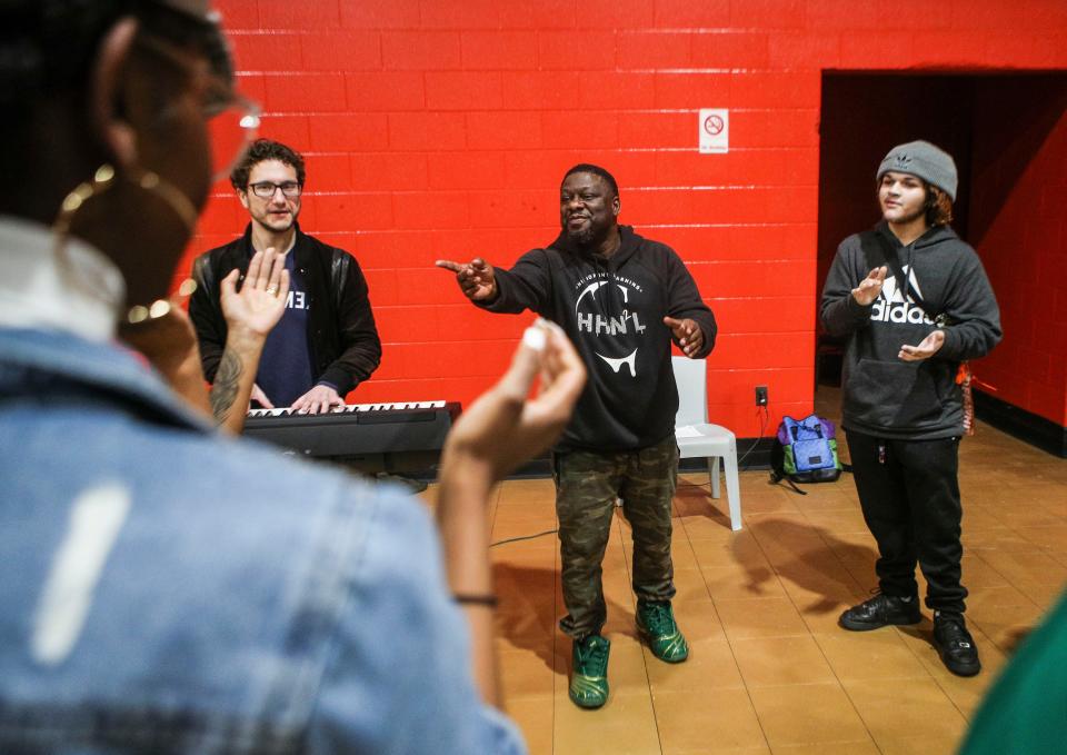 Antonio Taylor instructs some teens during a music session that's part of the Real Young Prodigys program. Taylor is the husband of NyRee Clayton-Taylor, who oversees the group. At left is Louisville Orchestra conductor Teddy Abrams, who was also working with the kids.