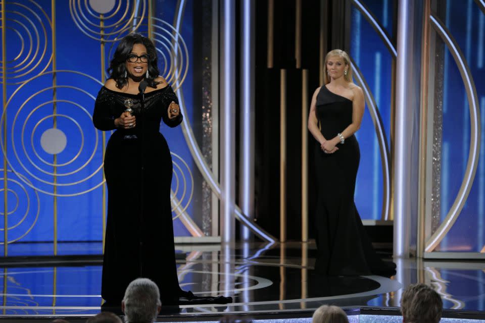 Reese looks on in awe as her friend Oprah delivers a historic speech at the Golden Globes. Source: Getty