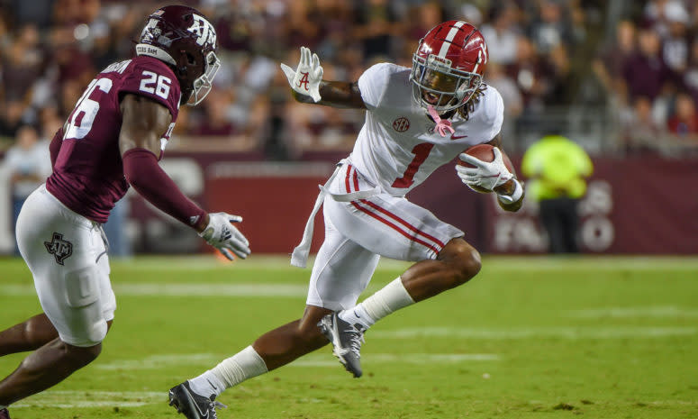 Jameson Williams runs with the football.