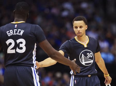 Apr 4, 2015; Dallas, TX, USA; Golden State Warriors guard Stephen Curry (30) and forward Draymond Green (23) react during the game against the Dallas Mavericks at American Airlines Center. Kevin Jairaj-USA TODAY Sports