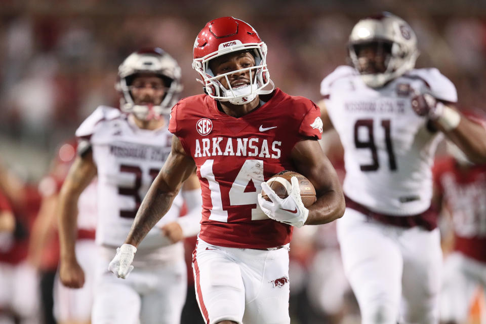 Sep 17, 2022; Fayetteville, Arkansas, USA; Arkansas Razorbacks punt returner Bryce Stephens (14) returns a punt for a touchdown against Missouri State Bears punter Grant Burkett (31) and defensive lineman JaÕVeo Toliver (91) in the fourth quarter at Donald W. Reynolds Razorback Stadium. Arkansas won 38-27. Mandatory Credit: Nelson Chenault-USA TODAY Sports