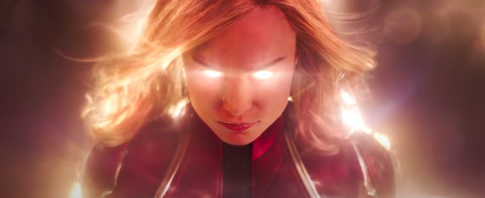 Carol's eyes light up and her hair blows in the wind as her power surges from within