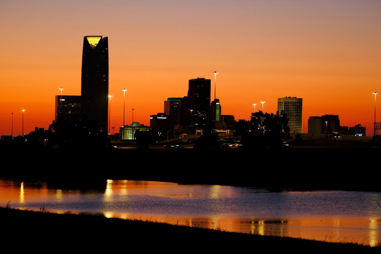 The Oklahoma City downtown skyline at sunset is reflected in the Oklahoma River on Sept. 19, 2021.
