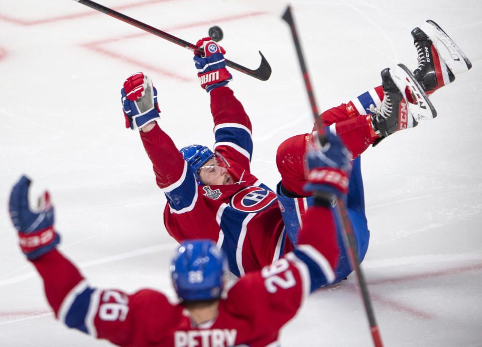 Montreal Canadiens' Josh Anderson (17) slides on the ice while celebrating after scoring the winning goal at the end of overtime of Game 4 of the NHL hockey Stanley Cup final against the Tampa Bay Lightning in Montreal, Monday, July 5, 2021. (Ryan Remiorz/The Canadian Press via AP)