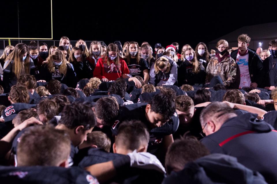 Southridge students stand behind the football team as Southridge Head Coach Scott Buening gives his final words on the season after losing the Class 3A semi-state game against the Danville Warriors in Huntingburg, Ind., Friday evening, Nov. 20, 2020. Danville won 7-30. Danville won 30-7.