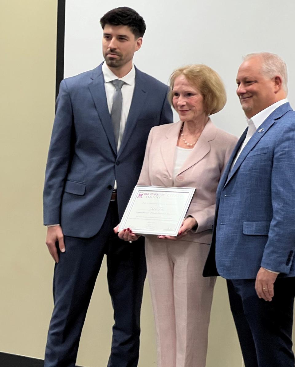 Fox, center, was honored by the group for her efforts to bring South Coast Rail to fruition. Left, Ian Trombly, vice president of public policy for One SouthCoast Chamber; right, Coalition Chairman and Realtor Association of Southeastern Massachusetts CEO Paul Chasse.