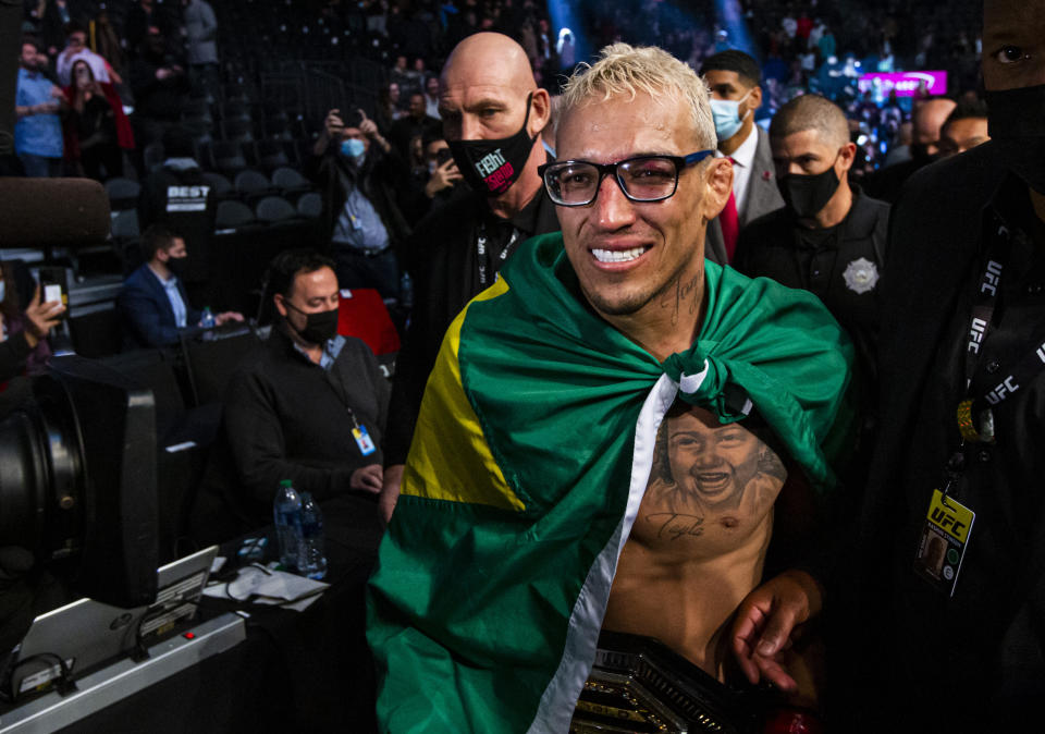 Charles Oliveira leaves the arena after defeating Dustin Poirier, not pictured, by submission in a lightweight mixed martial arts title bout at UFC 269, Saturday, Dec. 11, 2021, in Las Vegas. (AP Photo/Chase Stevens)