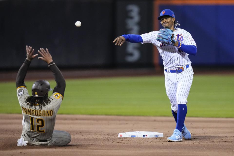 New York Mets' Francisco Lindor throws out San Diego Padres' Trent Grisham at first base after forcing out Luis Campusano, for a double play during the second inning of a baseball game Tuesday, April 11, 2023, in New York. (AP Photo/Frank Franklin II)