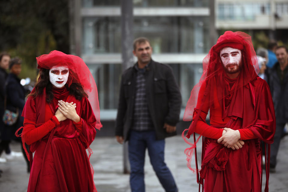 Extinction Rebellion climate change protesters call for action on climate change by staging an event against the fashion industry outside a shopping centre in Istanbul, Friday, Nov. 29, 2019. (AP Photo/Lefteris Pitarakis)