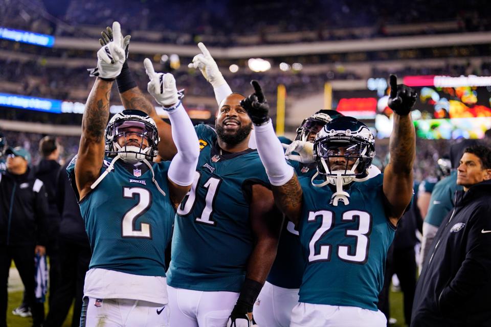 Philadelphia Eagles cornerback Darius Slay (2), defensive tackle Fletcher Cox (91) and safety C.J. Gardner-Johnson (23) gesture toward spectators during the second half of an NFL divisional round playoff football game against the New York Giants, Saturday, Jan. 21, 2023, in Philadelphia. (AP Photo/Matt Slocum)