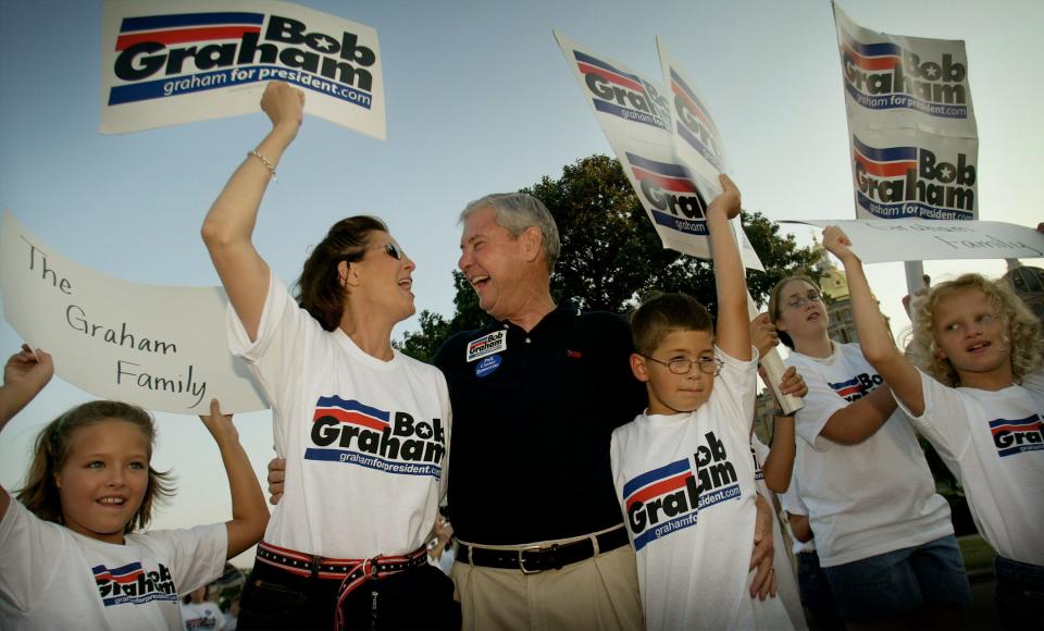 U.S. Sen. Bob Graham (D-FL), a candidate for president, along with family members, cheers in the staging area of the Iowa State Fair Parade August 6, 2003 in downtown Des Moines, Iowa.