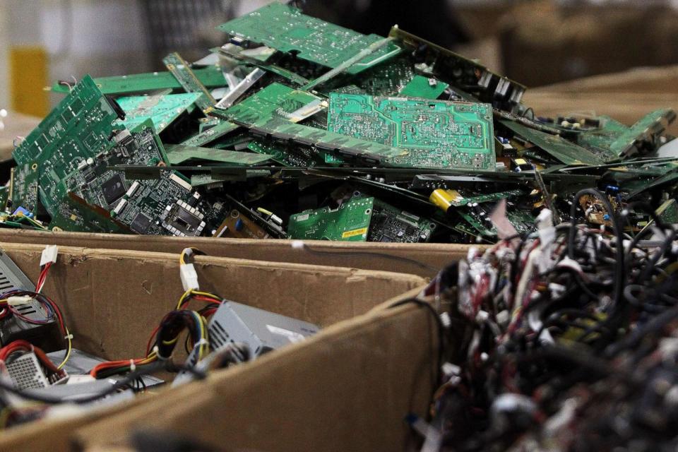 PHOTO: Piles of wires, motherboards and other electronic parts fill boxes at E-Waste Recycling Center, Dec. 4, 2014. (Genna Martin/The Herald/AP Photo)