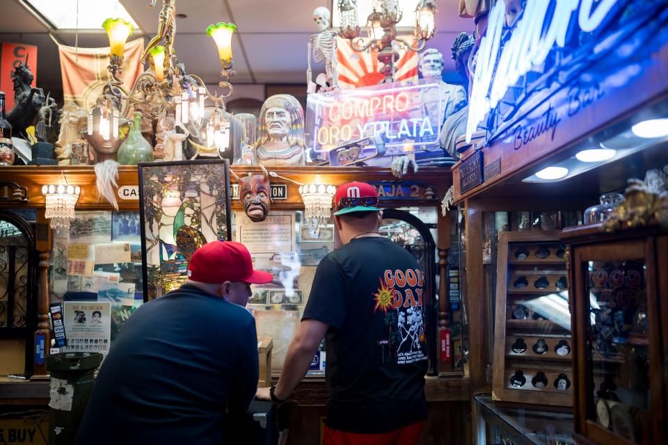 Customer check on the value of a piece of jewelry at Dave's A Pawn Shop at 216 S El Paso Street in El Paso, TX, on Tuesday, March 12, 2024.