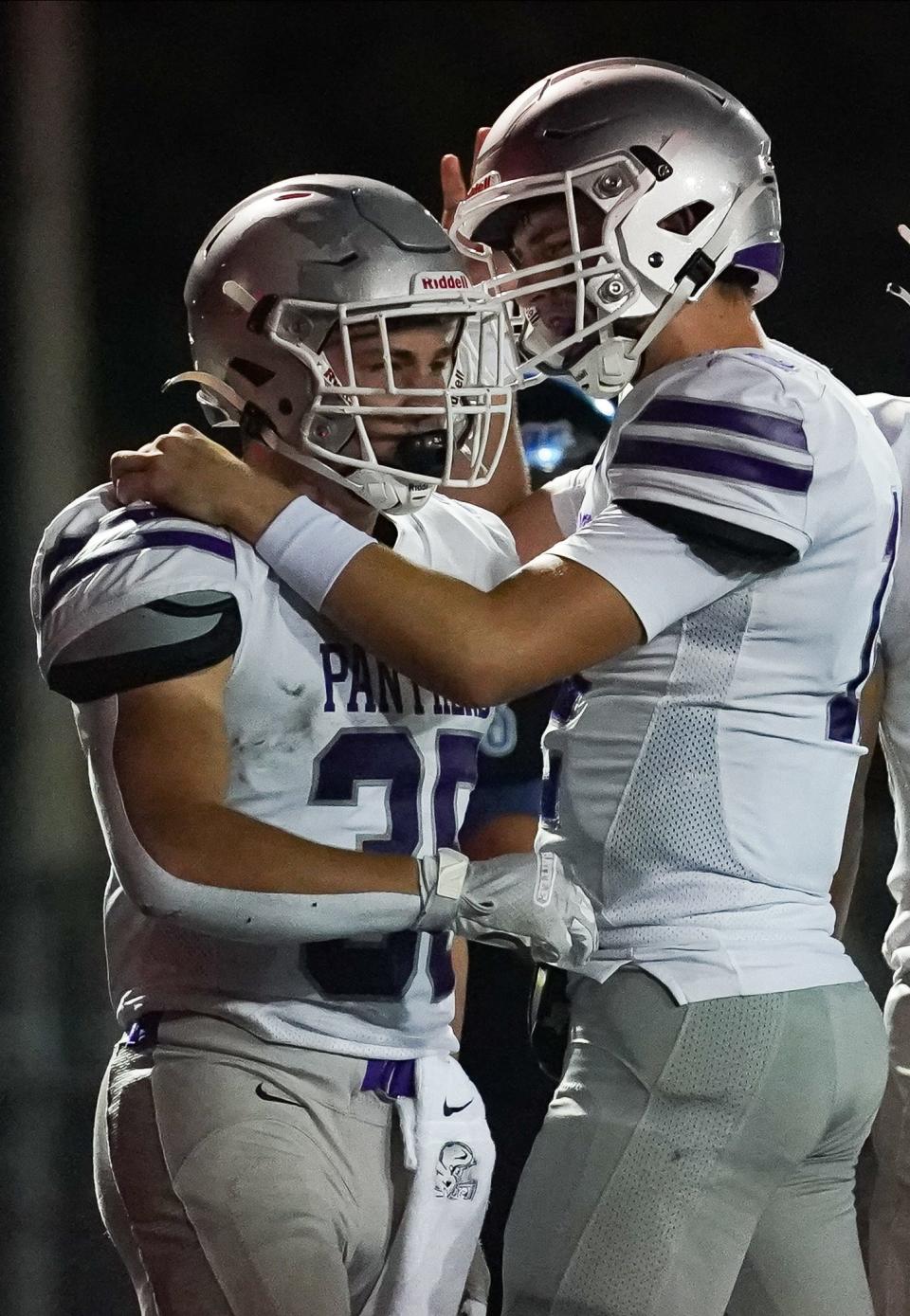 Bloomington South’s Gavin Adams (35) is congratulated by Bloomington South’s Jarrin Alley (right) after scoring a touchdown during the football game against Columbus North at North on Friday, Sept. 29, 2023.