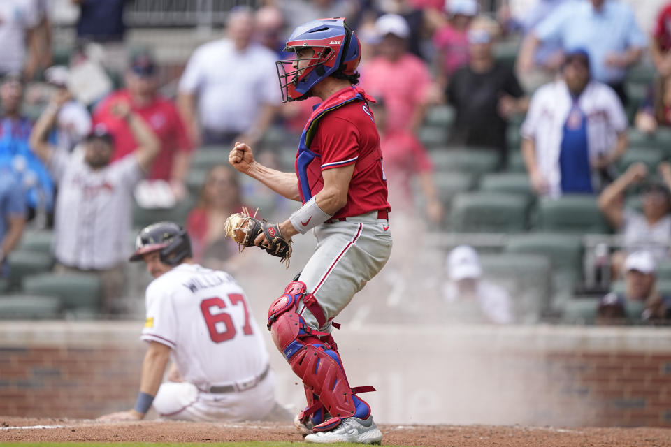 Philadelphia Phillies catcher Garrett Stubbs (21) celebrates after tagging out Atlanta Braves' Luke Williams (67) in the ninth inning of a baseball game against the Wednesday, Sept. 20, 2023, in Atlanta. (AP Photo/Brynn Anderson)