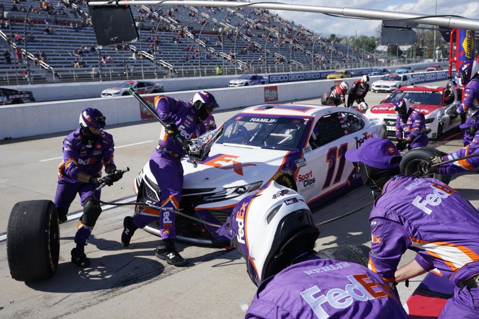 Denny Hamlin (11) gets service in the pits during the NASCAR Cup Series auto race at Martinsville Speedway in Martinsville, Va., Sunday, April 11, 2021. (AP Photo/Steve Helber)