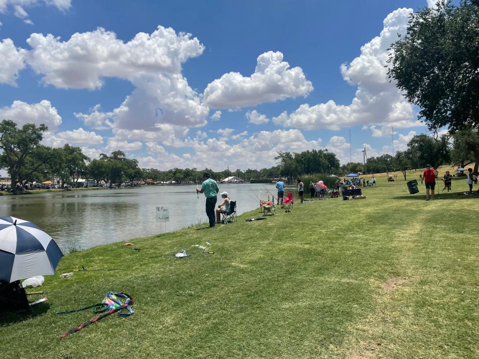 Families fish during the 6th annual Fishing Tournament.