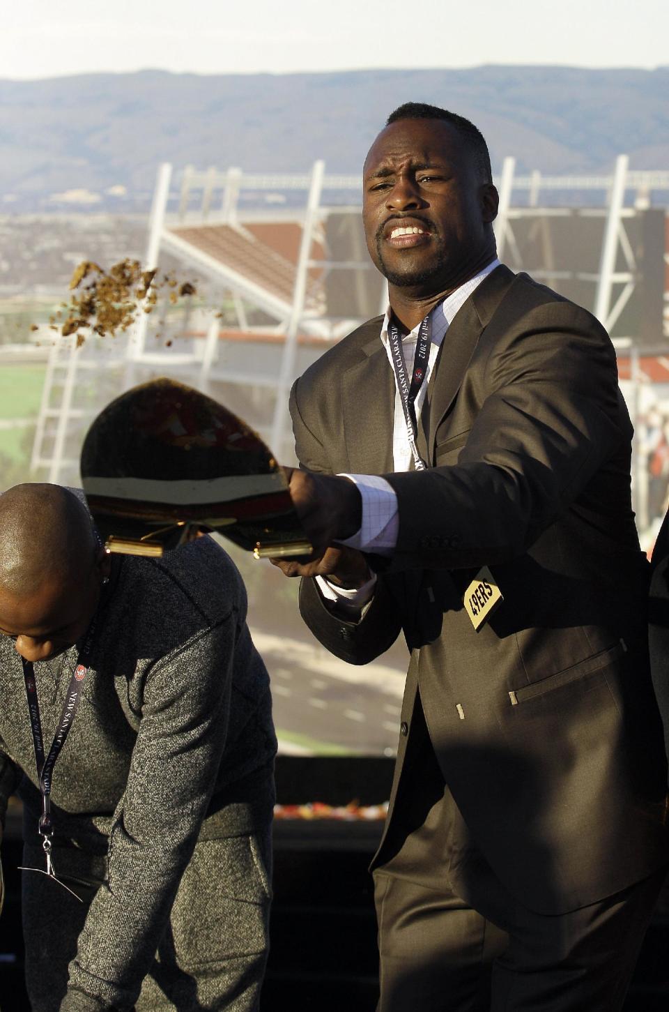 San Francisco 49ers tight end Vernon Davis shovels up dirt at a groundbreaking ceremony at the construction site for the 49ers' new NFL football stadium in Santa Clara, Calif., Thursday, April 19, 2012. (AP Photo/Jeff Chiu)