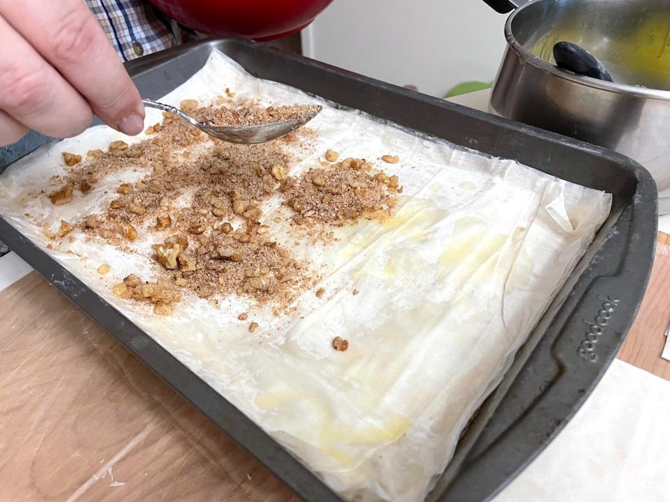 Adding walnuts to phyllo for Anneta's dad's baklava