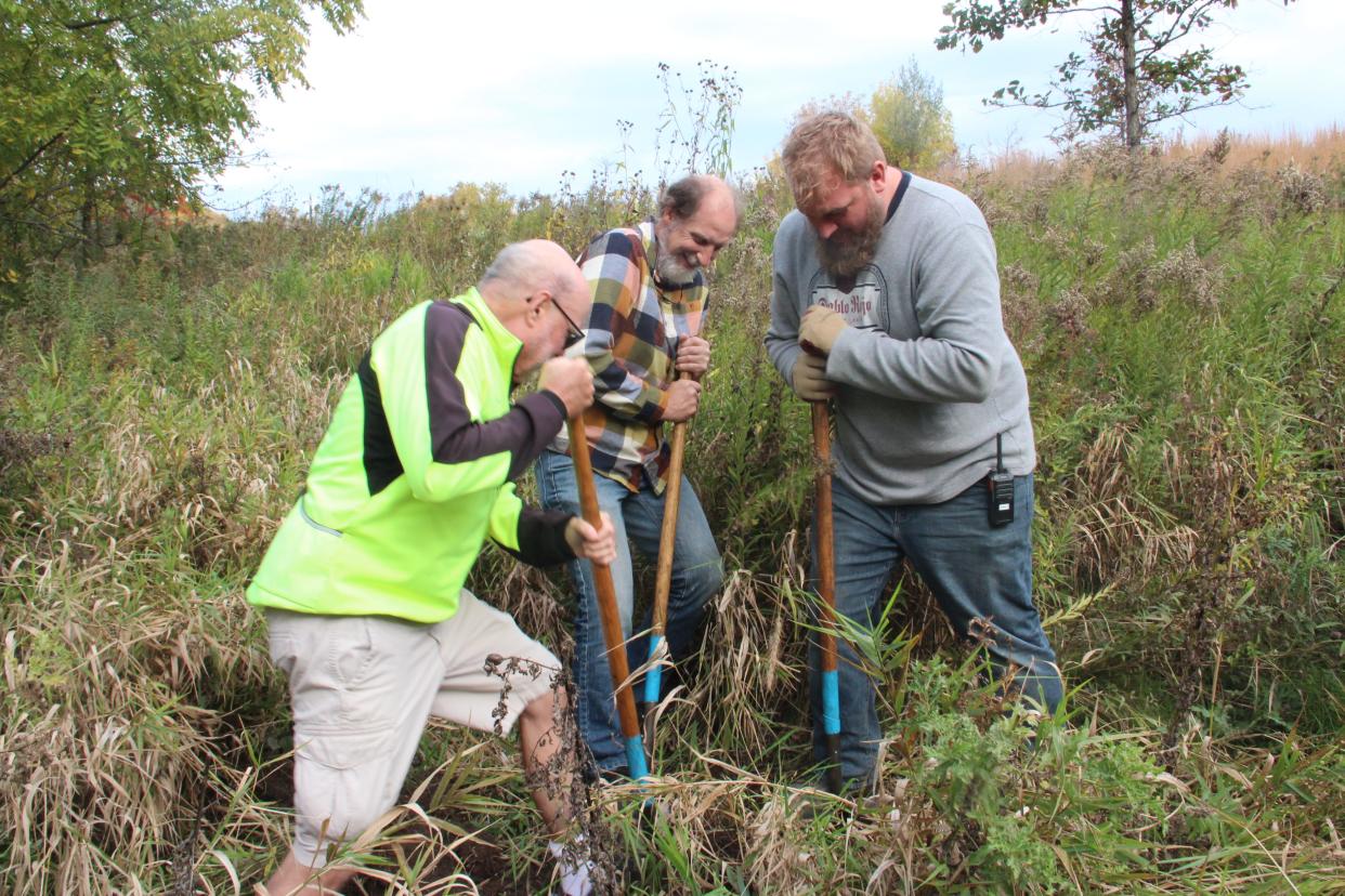 Ken Leinbach, center, helps plant an oak tree Oct. 18 at the Rotary Centennial Arboretum at the Urban Ecology Center's Riverside Park location. Leinback retired as UEC's executive director in June after 25 years. Assisting him in the tree planting are UEC volunteer Kevin Whaley (left) and Jeremy Rappaport, UEC land steward.