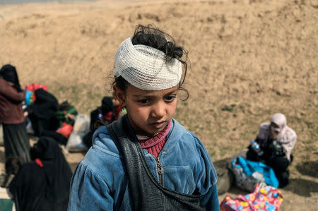 A displaced Iraqi girl who just fled her home, waits to be transported while Iraqi forces battle with Islamic State militants in western Mosul, Iraq February 27, 2017. REUTERS/Zohra Bensemra