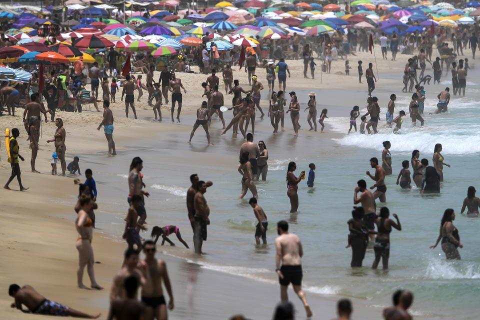 Despite restrictions to limit the spread of COVID-19, thousands crowd Ipanema Beach in Rio de Janeiro, Brazil, Sunday, Jan. 24, 2021. (AP Photo/Bruna Prado)