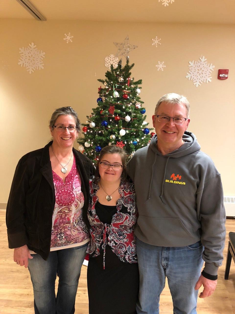 Grace Schara, center, with parents Cindy and Scott Schara.