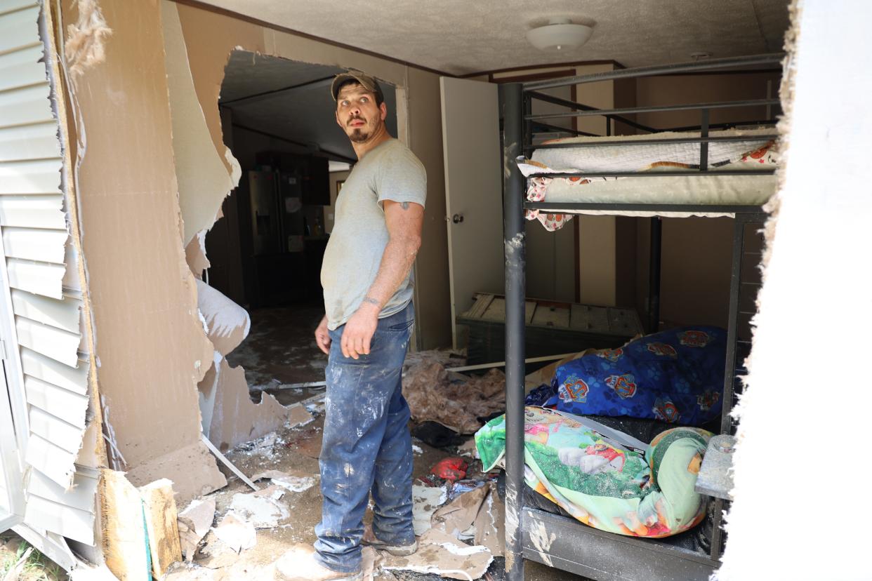 Dustin Elam, 31, stands in his children's former bedroom after his home was destroyed by flooding in Breathitt County Kentucky.