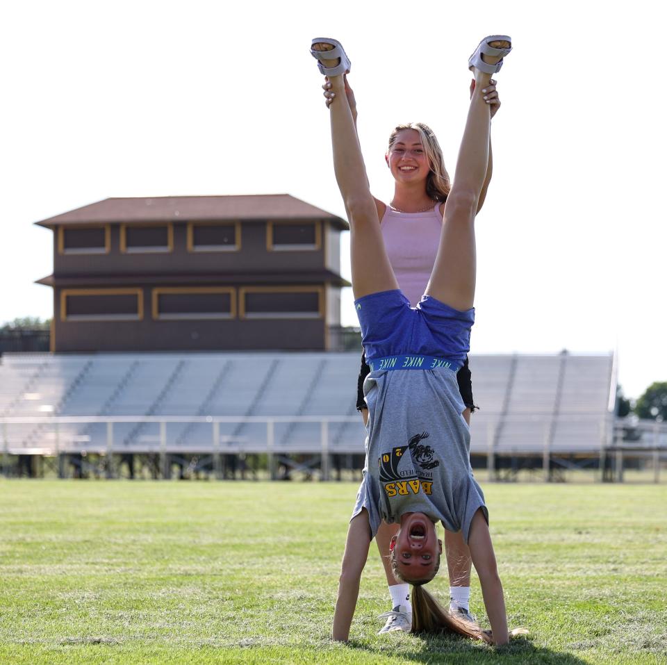 Waynedale's Alyce Yoder (back) and Sydney Reber have a fun moment as they prepare this week for their third trip to state this school year as part of the 3200 relay team.