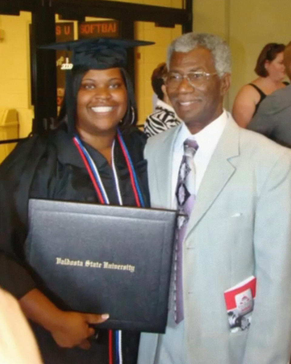 This 2009 photo provided by Tressa Clements shows her daughter, Saferia Johnson, with her grandfather, Lindsey Johnson Sr., during celebrations for Saferia's graduation from Valdosta State University in Georgia. Johnson earned a reputation as a mentor and mother figure to many and time and again, she was a fast friend, who followed a chance encounter with an outflow of kindness that ensured would-be strangers instead lived lives forever intertwined. In August 2020, she died at the age of 36 from COVID-19. (Tressa Clements via AP)