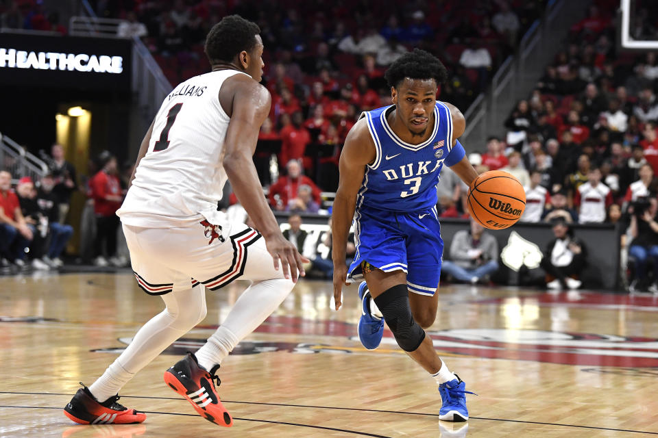 Duke guard Jeremy Roach (3) attempts to drive past Louisville guard Curtis Williams (1) during the first half of an NCAA college basketball game in Louisville, Ky., Tuesday, Jan. 23, 2024. (AP Photo/Timothy D. Easley)