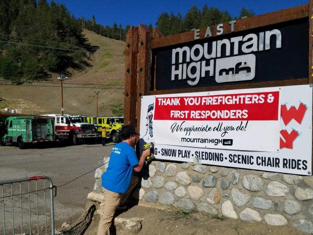 In Wrightwood, a Mountain High ski resort employee posts a sign appreciating firefighters for efforts in battling the Sheep Fire that began Saturday and was nearly full contained on Thursday.