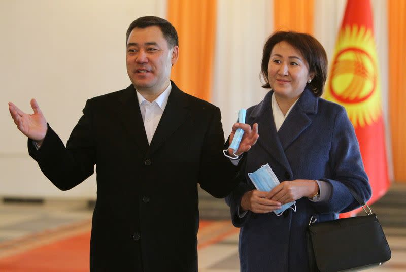 Presidential candidate Sadyr Japarov and his wife Aigul pose for a picture during a presidential election and constitutional referendum in Bishkek