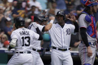 Detroit Tigers' Eric Haase (13), Robbie Grossman, center, and Jonathan Schoop celebrate after all scored on Haase's three-run home run to left field during the first inning of a baseball game against the Texas Rangers, Thursday, July 22, 2021, in Detroit. (AP Photo/Carlos Osorio)