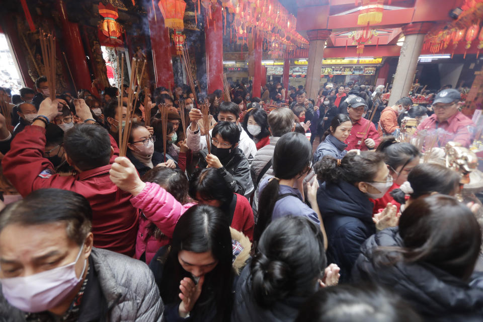 Worshippers go to pray at a temple on the first day of the Lunar New Year celebrations in Taipei, Taiwan, Saturday, Feb. 10, 2024. Each year is named after one of the 12 signs of the Chinese zodiac in a repeating cycle, with this year being the Year of the Dragon. (AP Photo/Chiang Ying-ying)