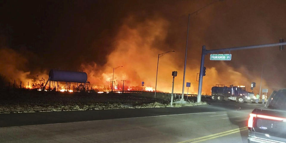 Fire and smoke fills the sky near the intersection at Hokiokio Place and Lahaina Bypass in Maui, Hawaii, on Aug. 8, 2023. (Zeke Kalua / County of Maui via AP)