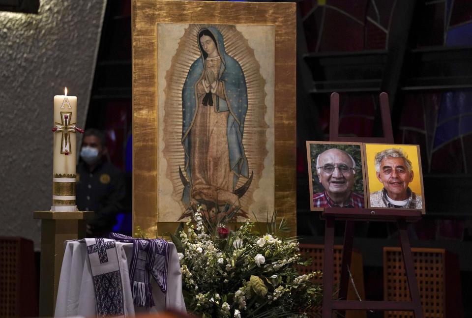 FILE - Framed images of Jesuit priests Javier Campos Morales, left, and Joaquin Cesar Mora Salazar are displayed on an altar during a memorial Mass in Mexico City, June 21, 2022. Two years have passed since a leader of one of Mexico’s organized crime stormed into a Catholic church in the remote Tarahumara mountains and shot the two Jesuit priests to death on June 20, 2022. (AP Photo/Fernando Llano, File)