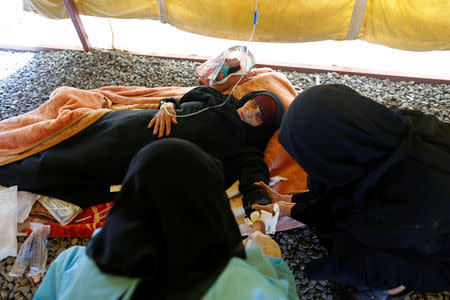 A woman suffering from cholera gets treatment in a tent at a cholera treatment center in Sanaa, Yemen March 10, 2019. Picture taken March 10, 2019. REUTERS/Khaled Abdullah