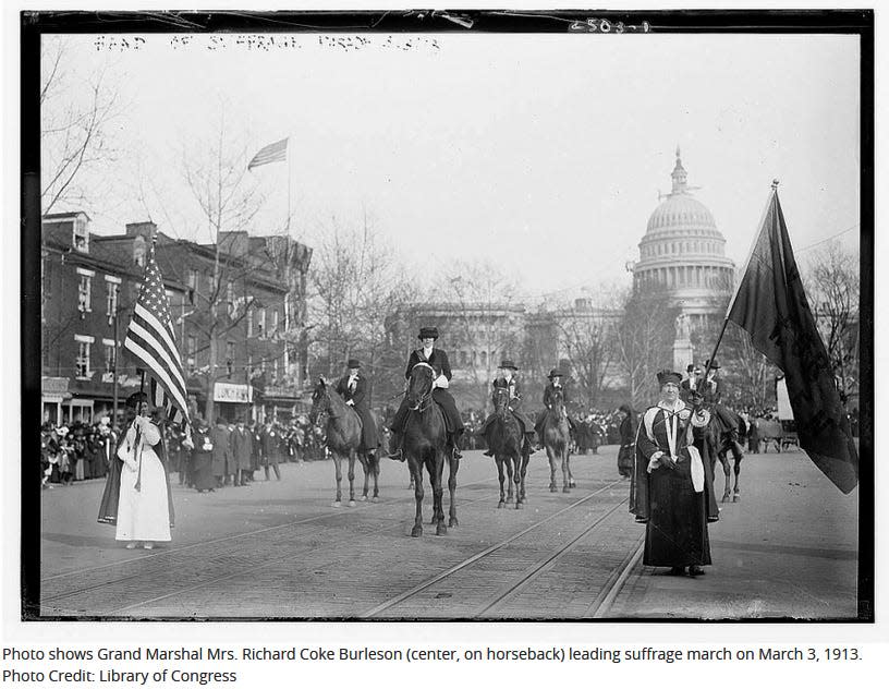 Photo shows Grand Marshal Mrs. Richard Coke Burleson (center, on horseback) leading suffrage march on March 3, 1913.